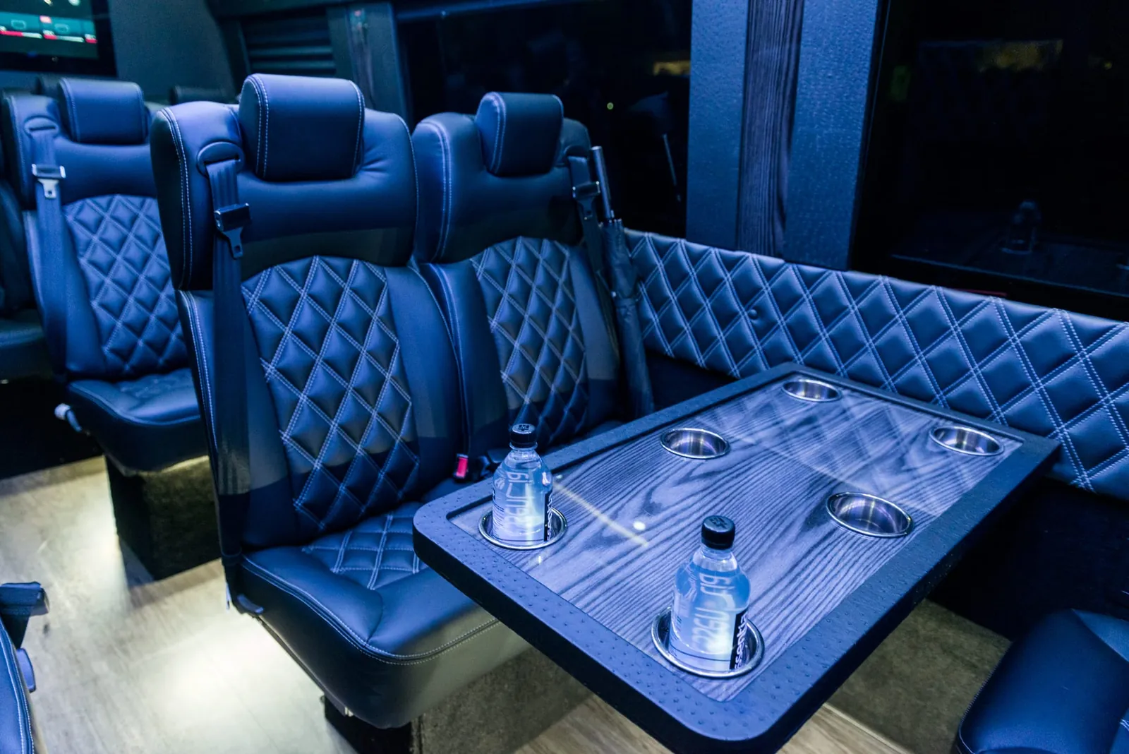 Executive Sprinter quilted seating and a table with cup holders — Shuttle Service New Jersey by Sprinter Van with Driver